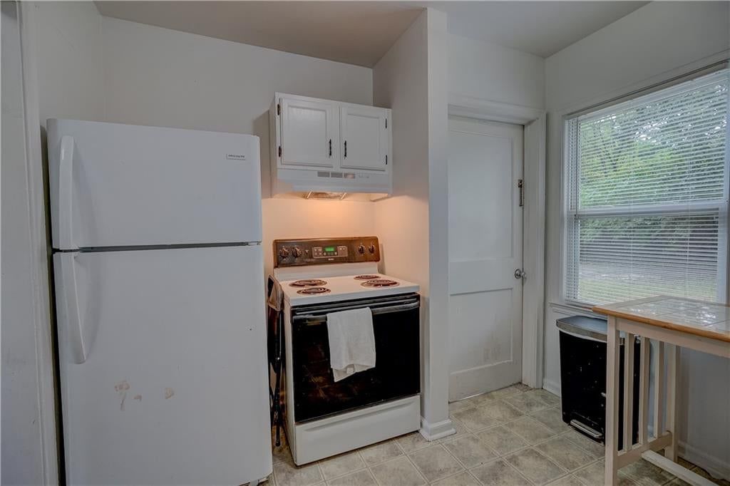 Open floor plan, white kitchen and butcher block countertops at 7411 E 83rd Street, Kansas City, MO 64138