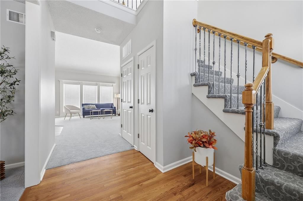 Hardwood floors, staircase and wood stair railing at 2325 W Piatt Lane, Olathe, KS 66061