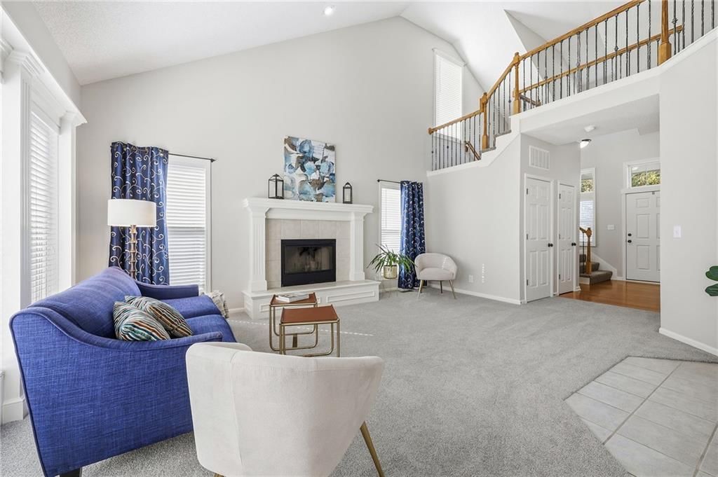 Tall ceilings, fireplace and two-story living room at 2325 W Piatt Lane, Olathe, KS 66061