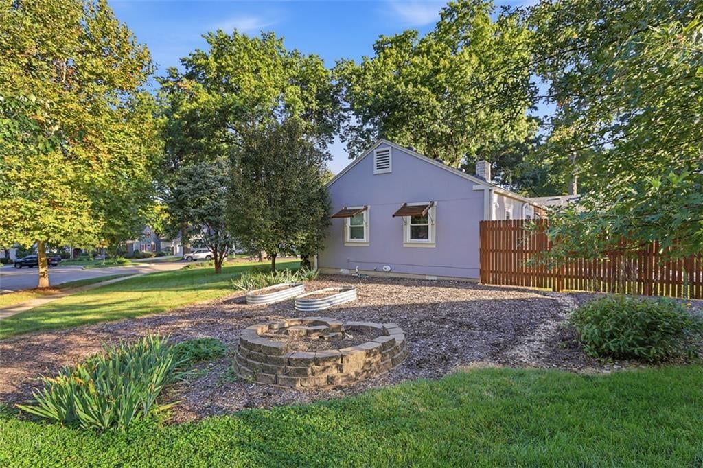 Fenced yard, fire pit and wood fence at 3007 W 73rd Terrace, Prairie Village, KS 66208