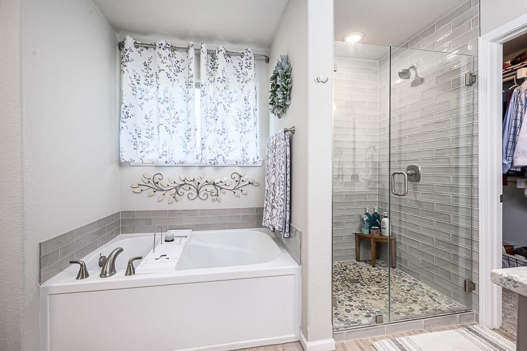 Walk-in shower, freestanding tub and tiled shower at 24315 W 76th Street, Shawnee, KS 66227