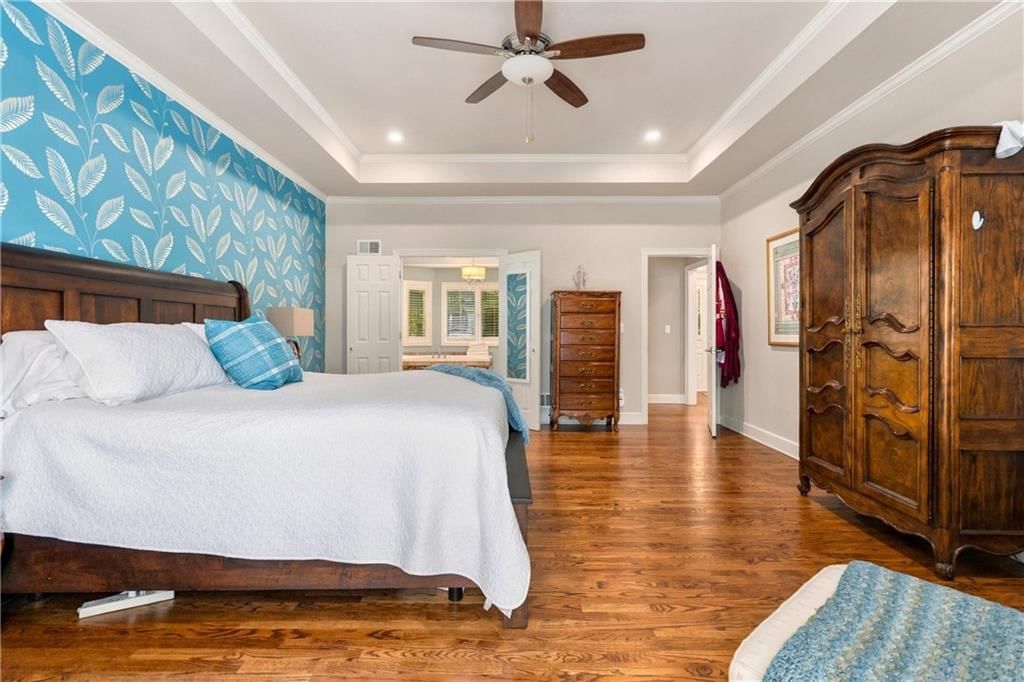 Main-floor primary bedroom, tray ceiling and carpet at 15592 S Greenwood Street, Olathe, KS 66062