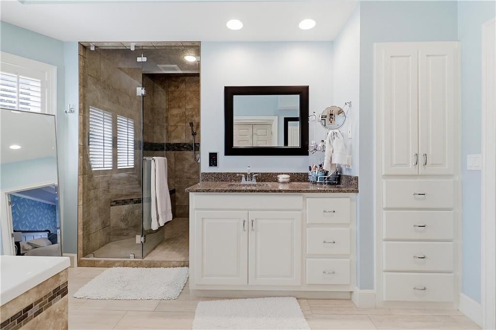 Freestanding tub, double vanity and white vanity at 15592 S Greenwood Street, Olathe, KS 66062