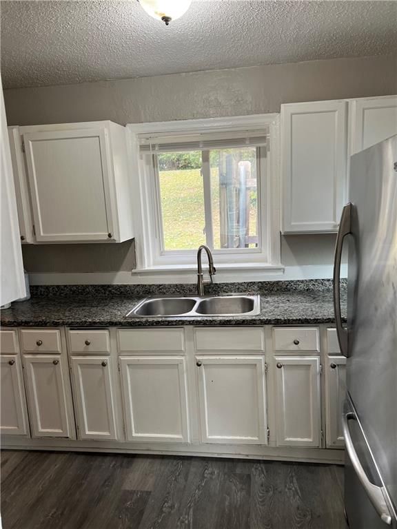 White kitchen, granite counters and wall of windows at 1836 E 77th Street, Kansas City, MO 64132