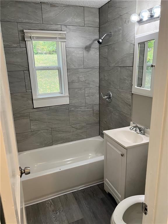 Tiled shower, renovated bathrooms and tub and shower combo at 1836 E 77th Street, Kansas City, MO 64132