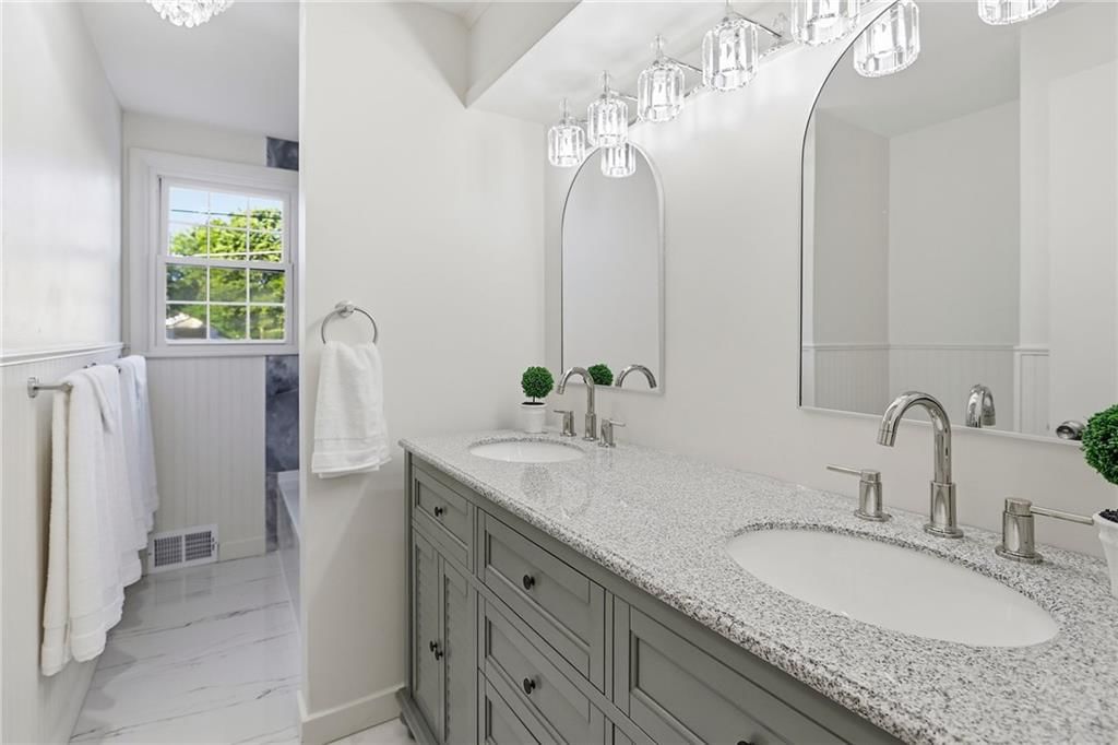 Double vanity and renovated bathrooms at 5909 Melrose Lane, Shawnee, KS 66203
