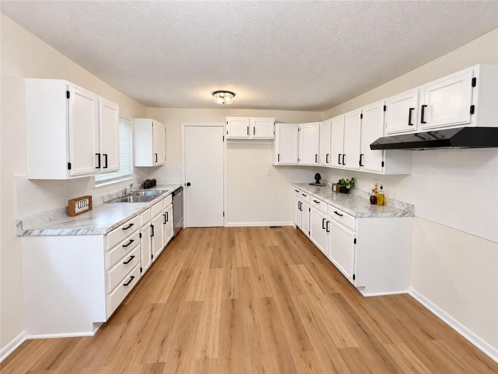 Open floor plan, white kitchen and shaker cabinets at 7209 E 86 Street, Kansas City, MO 64138