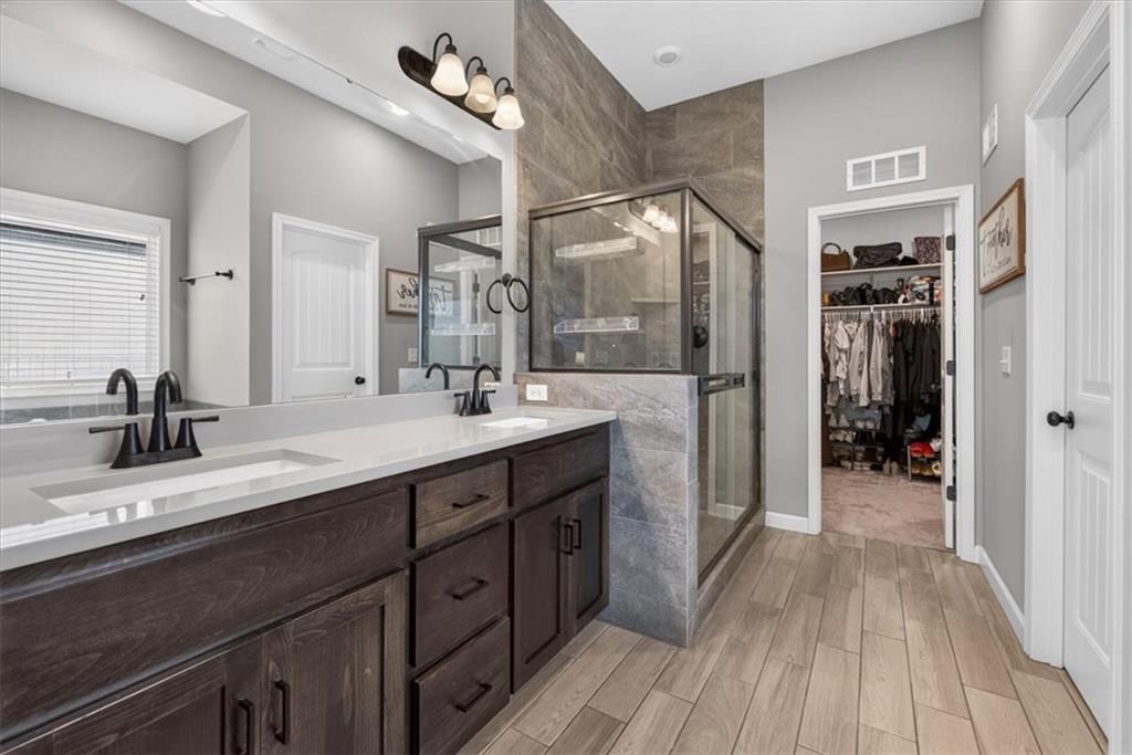 Double vanity, dark vanity color and black hardware at 504 Bentwater Drive, Raymore, MO 64083