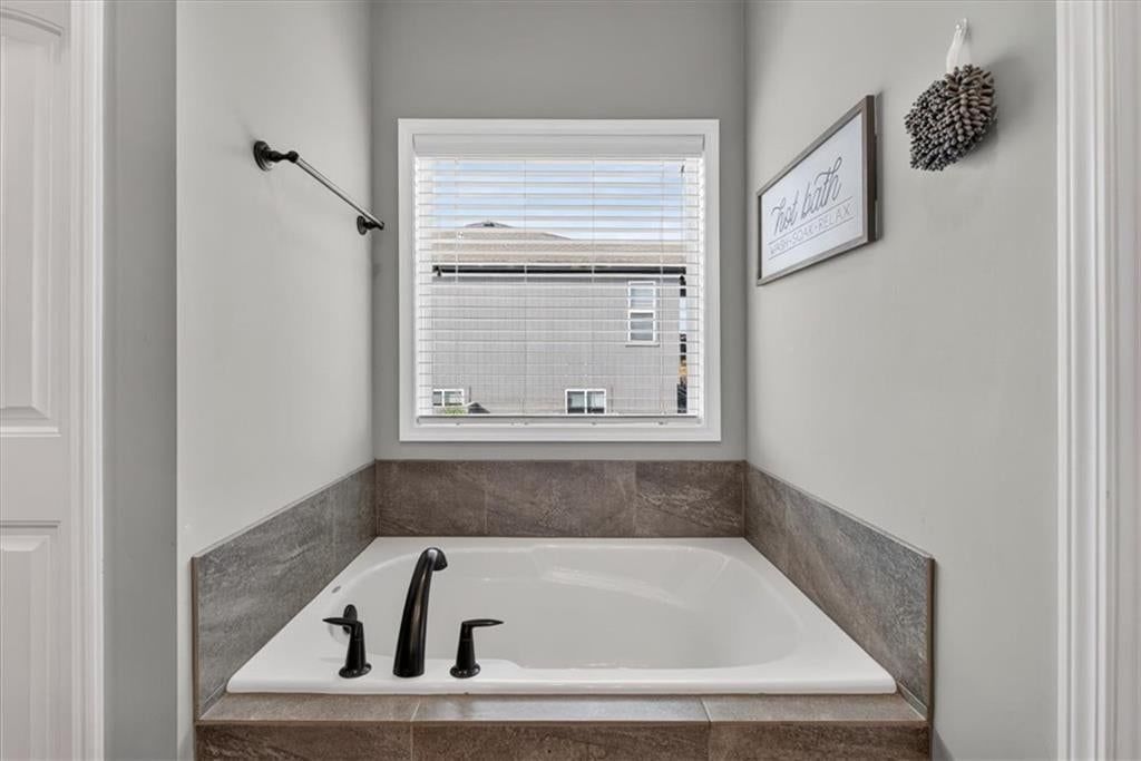 Tiled shower and frameless glass shower at 504 Bentwater Drive, Raymore, MO 64083