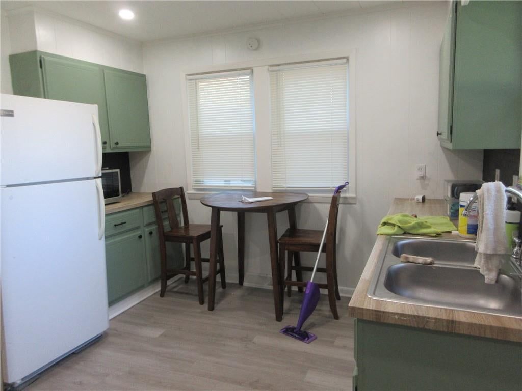Green kitchen cabinets and breakfast nook at 428 E Gudgell Avenue, Independence, MO 64055