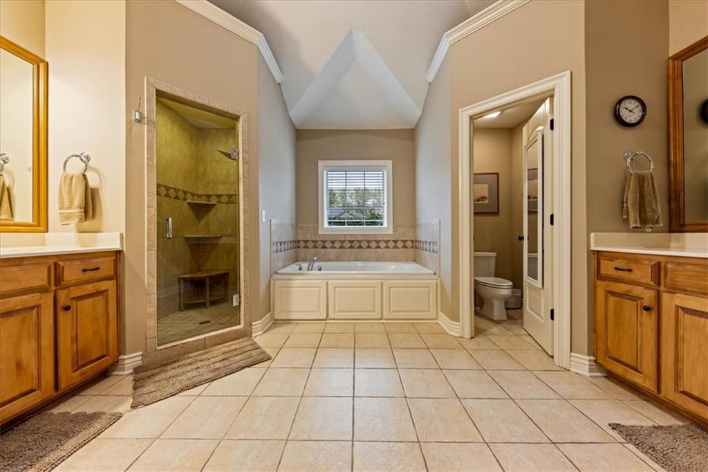 Tile floors, walk-in shower and private toilet room at 23716 W 52nd Terrace, Shawnee, KS 66226