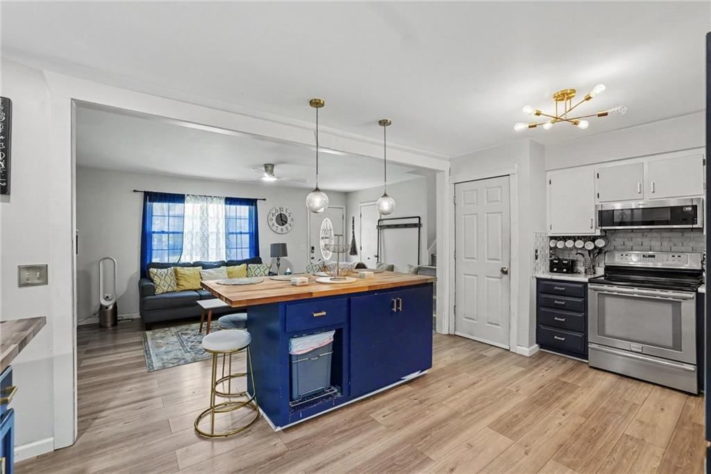 Open floor plan, kitchen island and hardwood floors at 2018 E Mohawk Court, Olathe, KS 66062