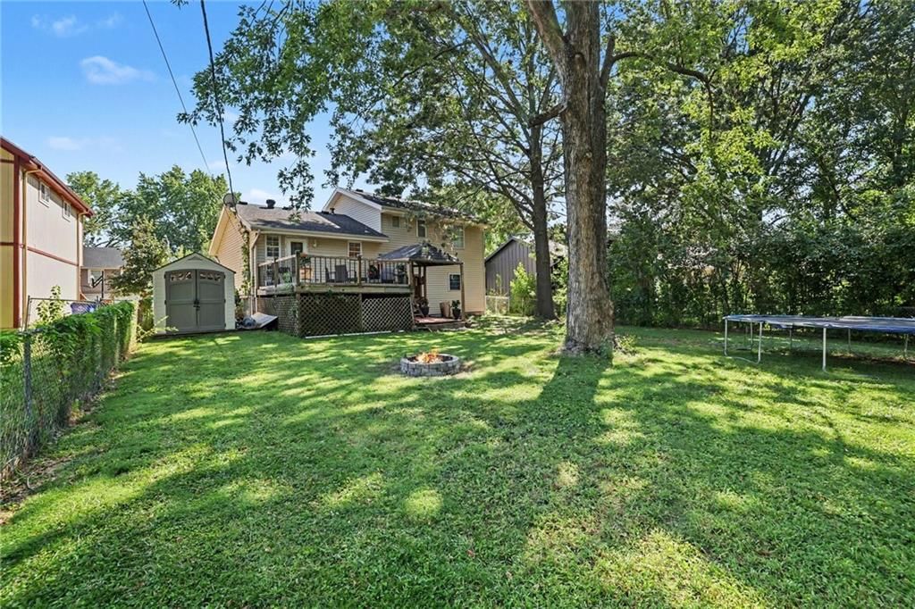 Deck, big backyard and fenced yard at 2018 E Mohawk Court, Olathe, KS 66062