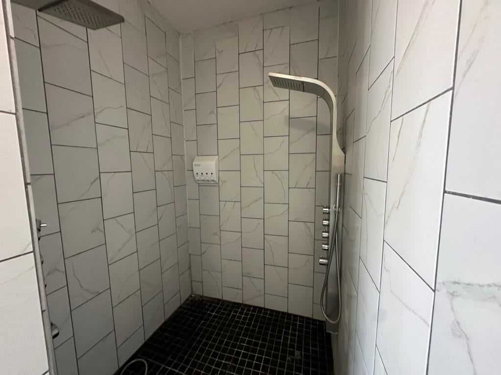 Tiled shower and frameless glass shower at 2807 7th Street E, Kansas City, MO 64124