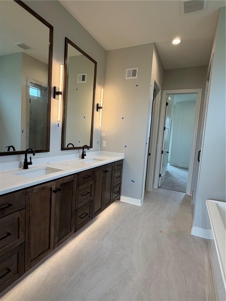 Tile floors and double vanity at 18461 Pawnee Lane, Overland Park, KS 66085