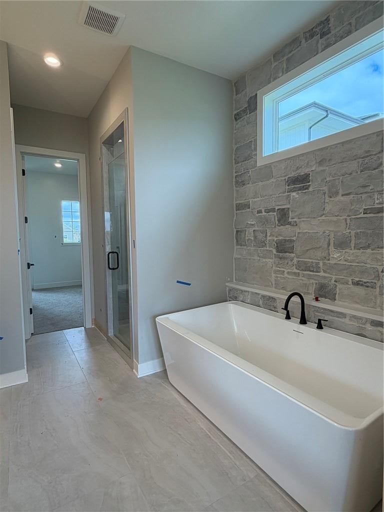 Walk-in shower, freestanding tub and tiled shower at 18461 Pawnee Lane, Overland Park, KS 66085