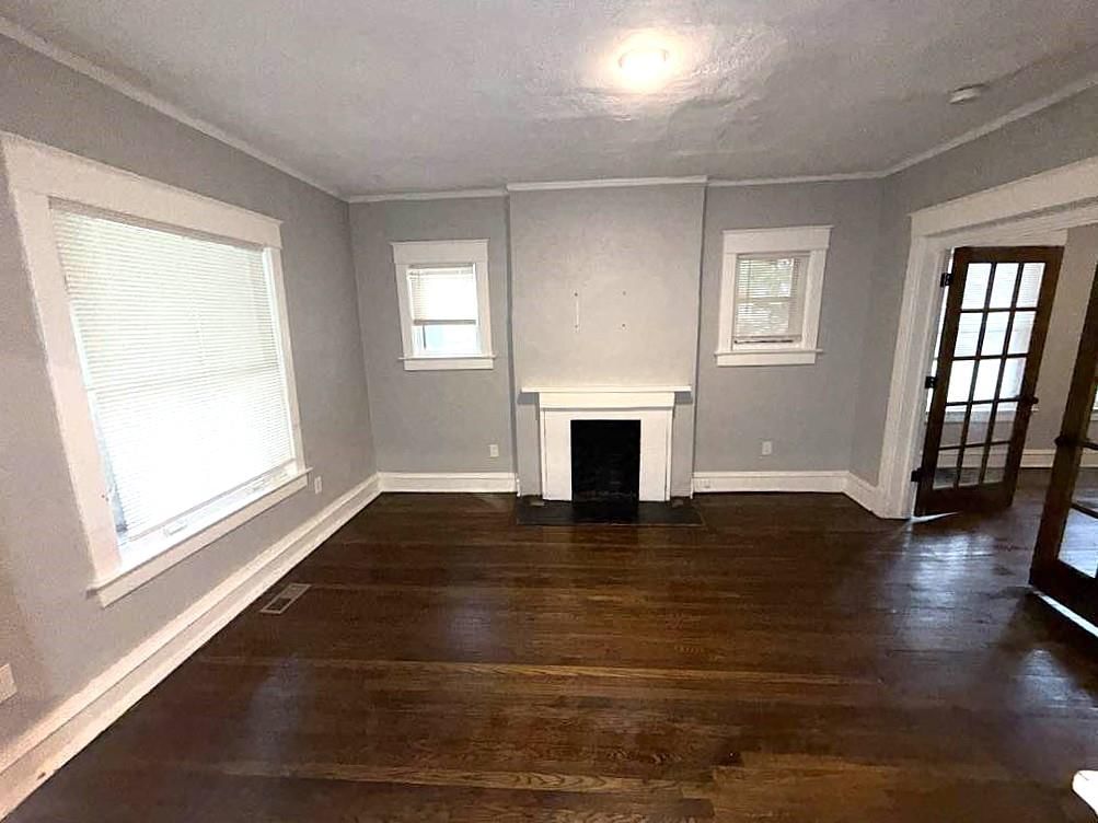 Fireplace, hardwood floors and white trim at 3249 E 28th Street, Kansas City, MO 64128
