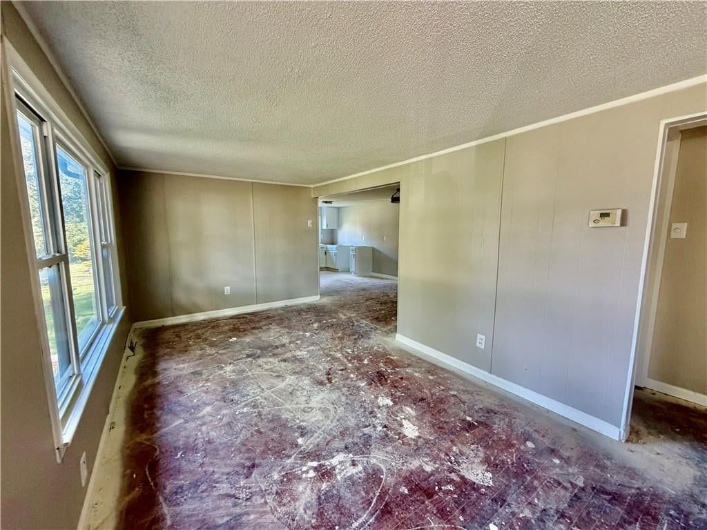 Open floor plan, main-floor primary bedroom and white trim at 1611 SE Willow Road, Lee's Summit, MO 64081