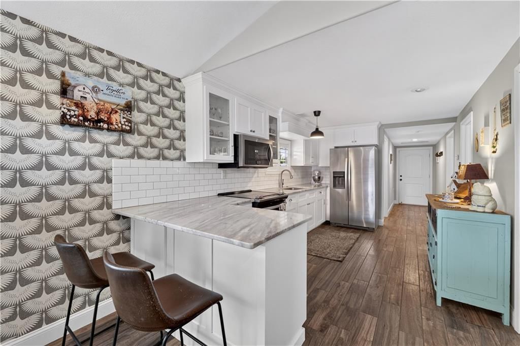 Open floor plan, kitchen island and quartz counters at 112 W Main Street, Freeman, MO 64746