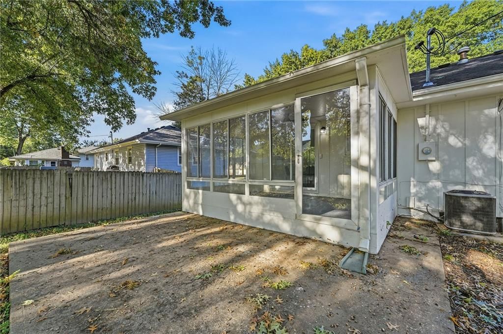 Fenced yard, mature trees and concrete patio at 1913 N Plymouth Road, Independence, MO 64058