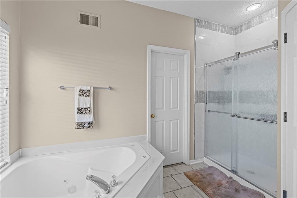 Walk-in shower and tiled shower at 628 NE 93rd Street, Kansas City, MO 64155