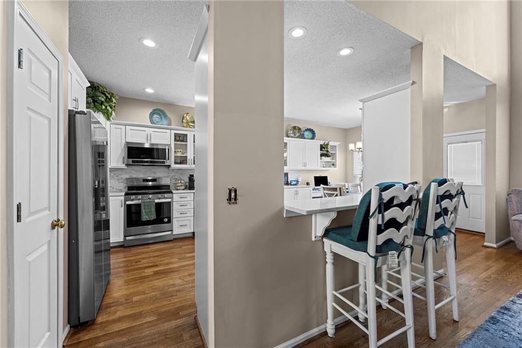 White kitchen, stainless steel appliances and updated kitchen at 628 NE 93rd Street, Kansas City, MO 64155