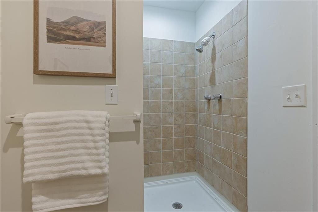 Walk-in shower and tiled shower at 4057 Walnut Street #6, Kansas City, MO 64111