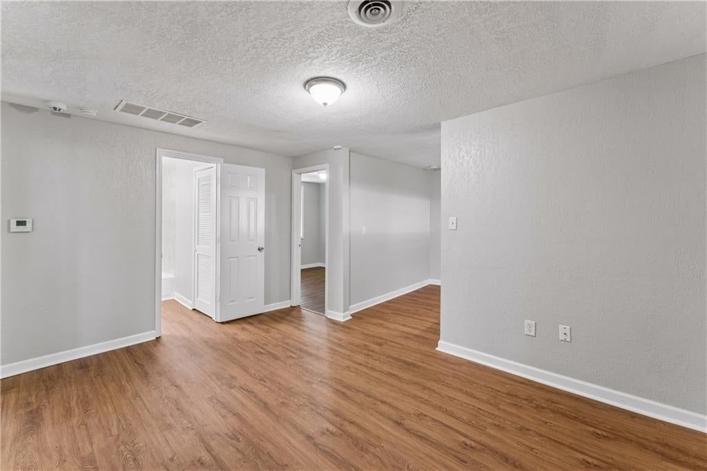 Main-floor primary bedroom, white trim and chrome hardware at 5304 Maywood Avenue, Raytown, MO 64133