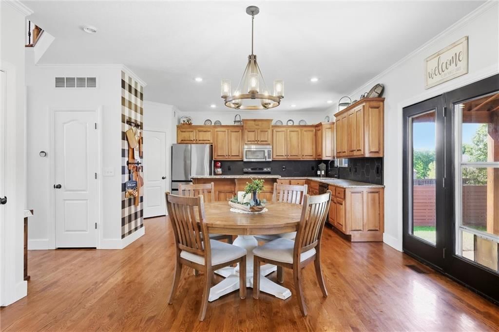 Statement lighting and breakfast nook at 110 S Eastglen Drive, Raymore, MO 64083