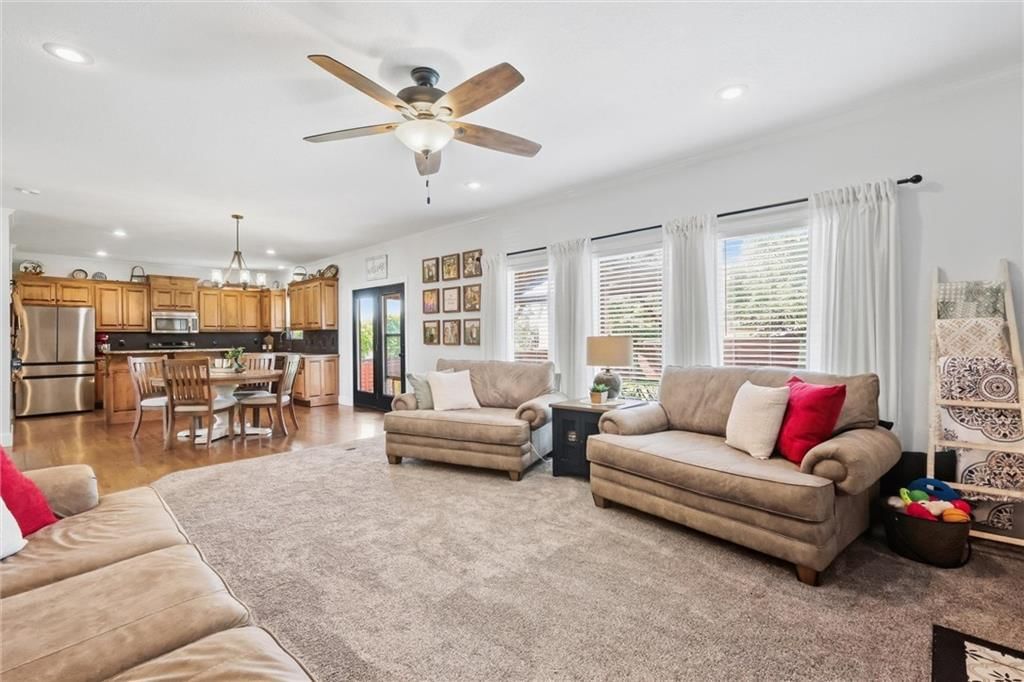 Tall ceilings, open floor plan and wall of windows at 110 S Eastglen Drive, Raymore, MO 64083