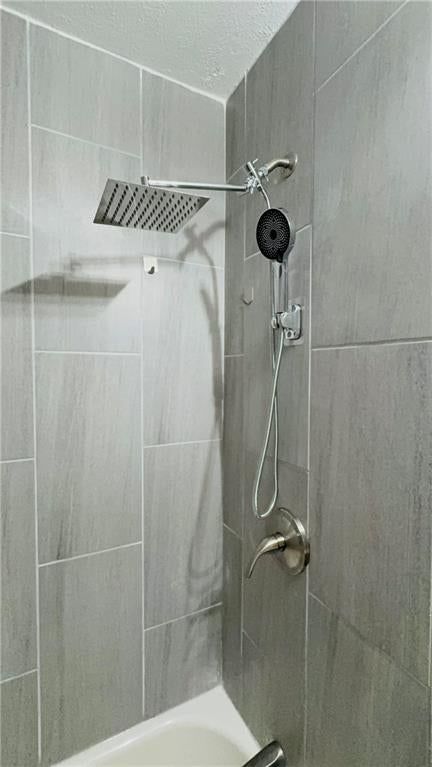 Tiled shower, frameless glass shower and renovated bathrooms at 6110 E 148TH Terrace, Grandview, MO 64030