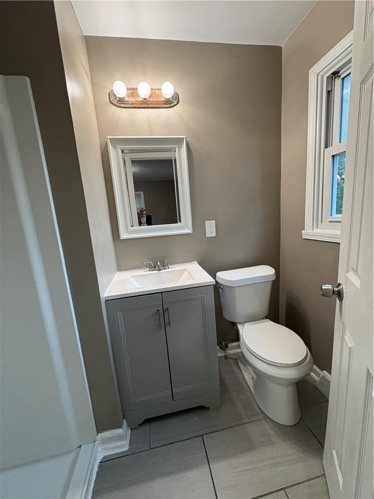 Statement lighting and gray vanity at 6110 E 148TH Terrace, Grandview, MO 64030