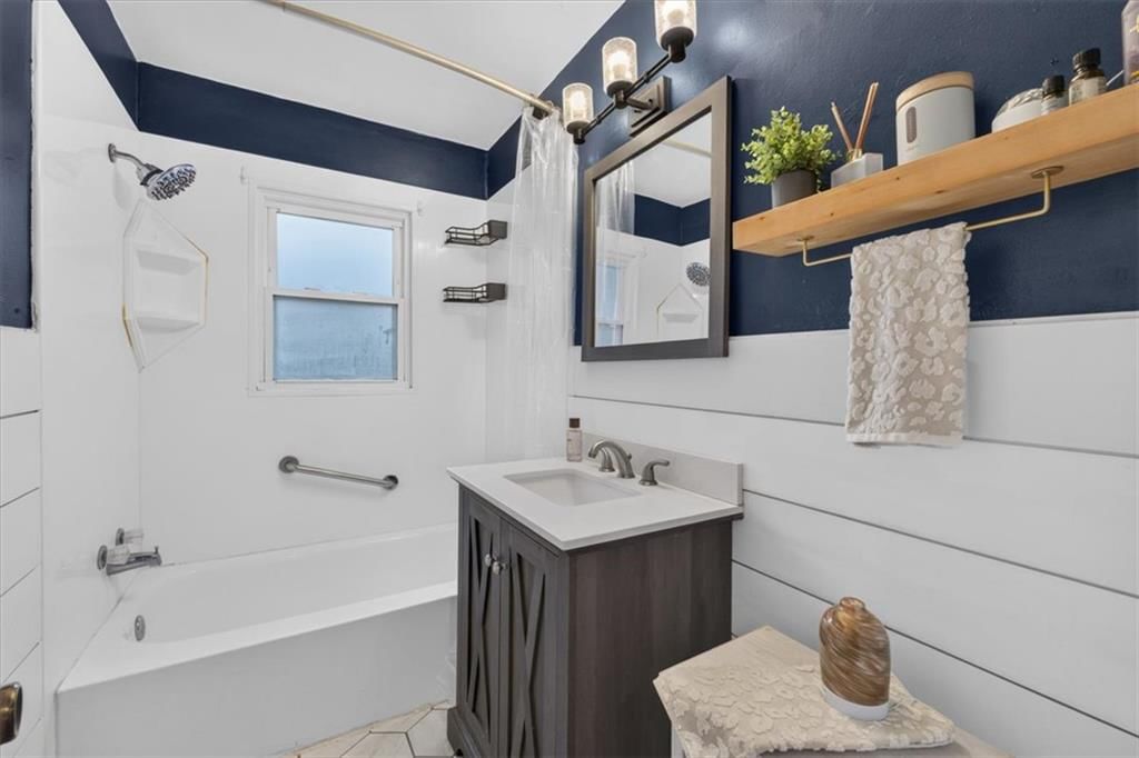Wainscoting or board and batten, shiplap / paneling and tiled shower at 3611 S Spring Street, Independence, MO 64055