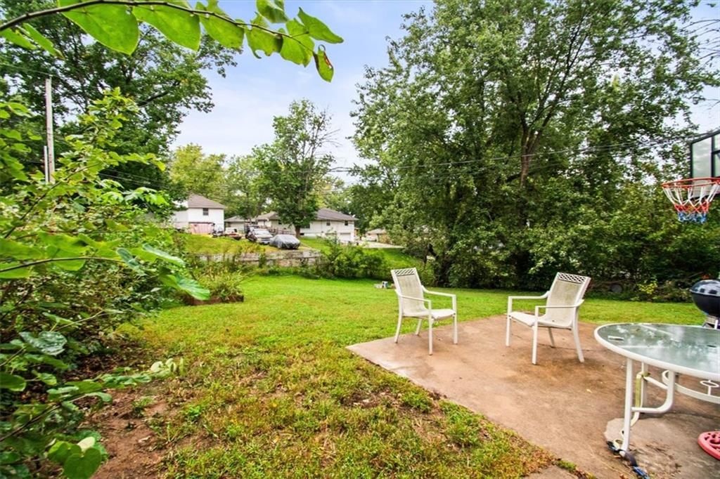 Big backyard, mature trees and concrete patio at 1708 N Kiger Road, Independence, MO 64050