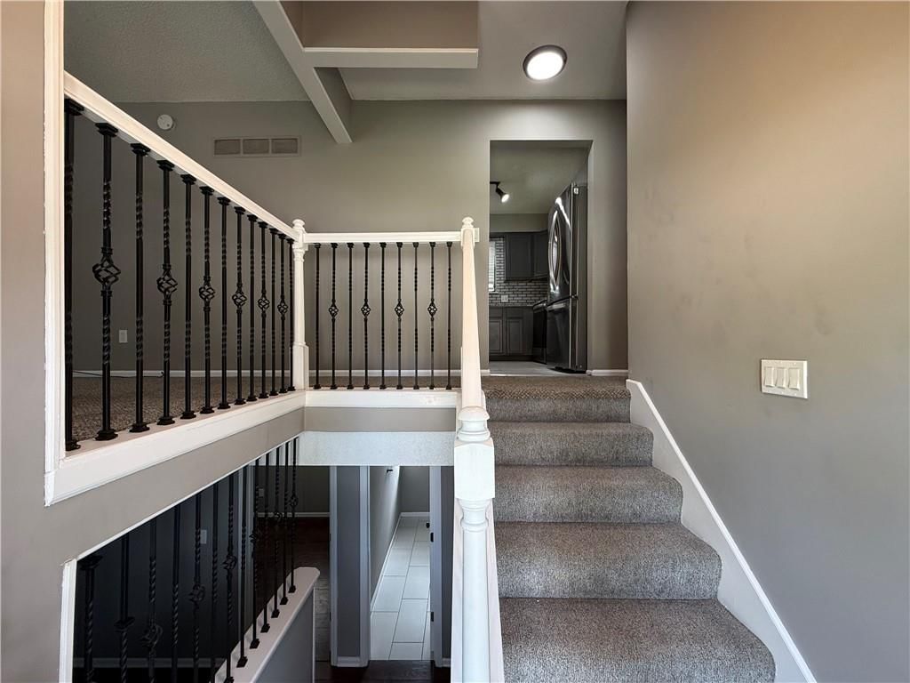 Staircase, iron stair railing and white trim at 1415 W Ferrel Drive, Olathe, KS 66061