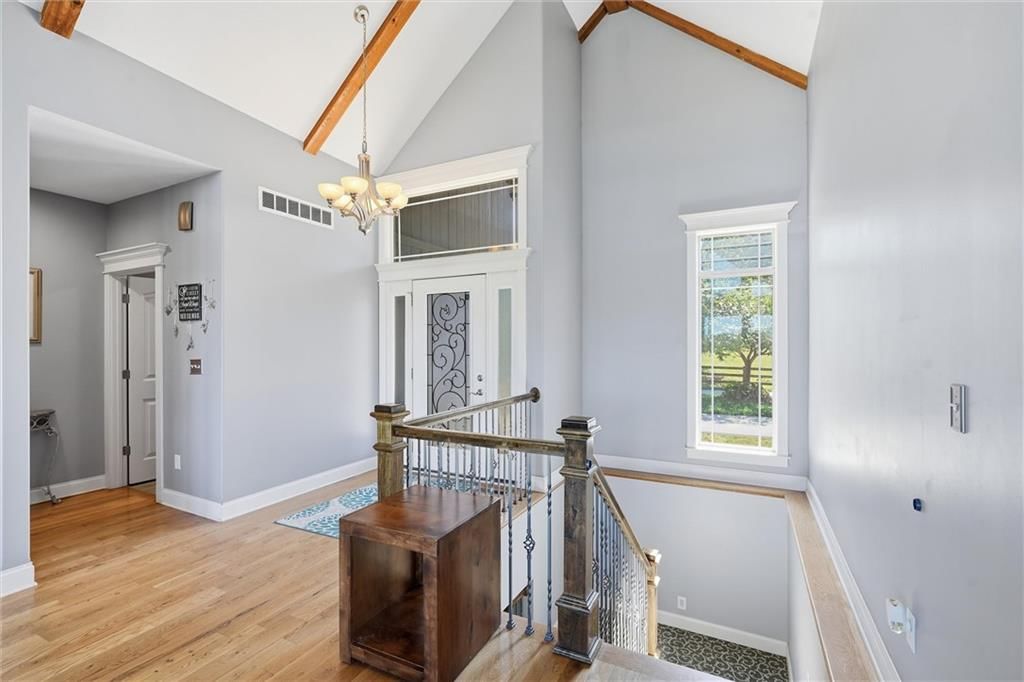Statement lighting, staircase and iron stair railing at 13012 E Lone Jack Lee's Summit Road, Lone Jack, MO 64086