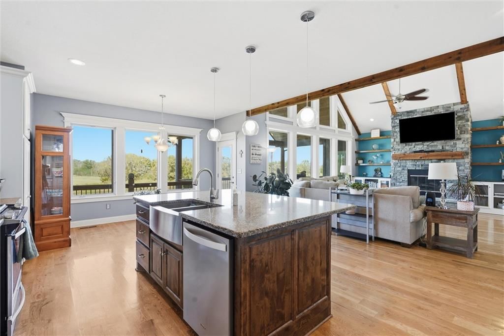 Kitchen island, white kitchen and granite counters at 13012 E Lone Jack Lee's Summit Road, Lone Jack, MO 64086