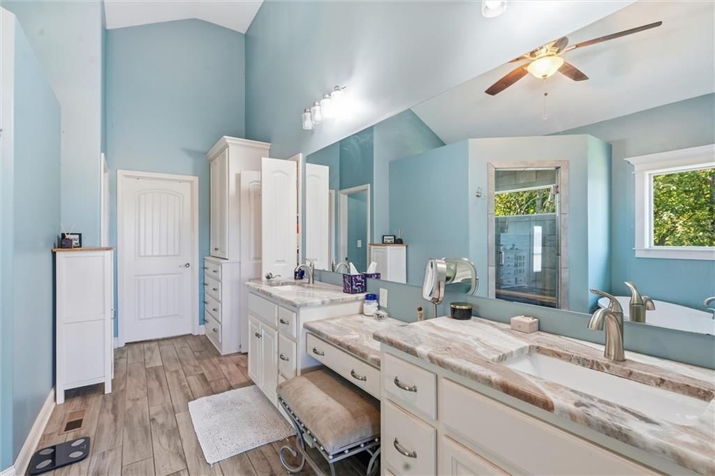 Walk-in shower, freestanding tub and tiled shower at 13012 E Lone Jack Lee's Summit Road, Lone Jack, MO 64086