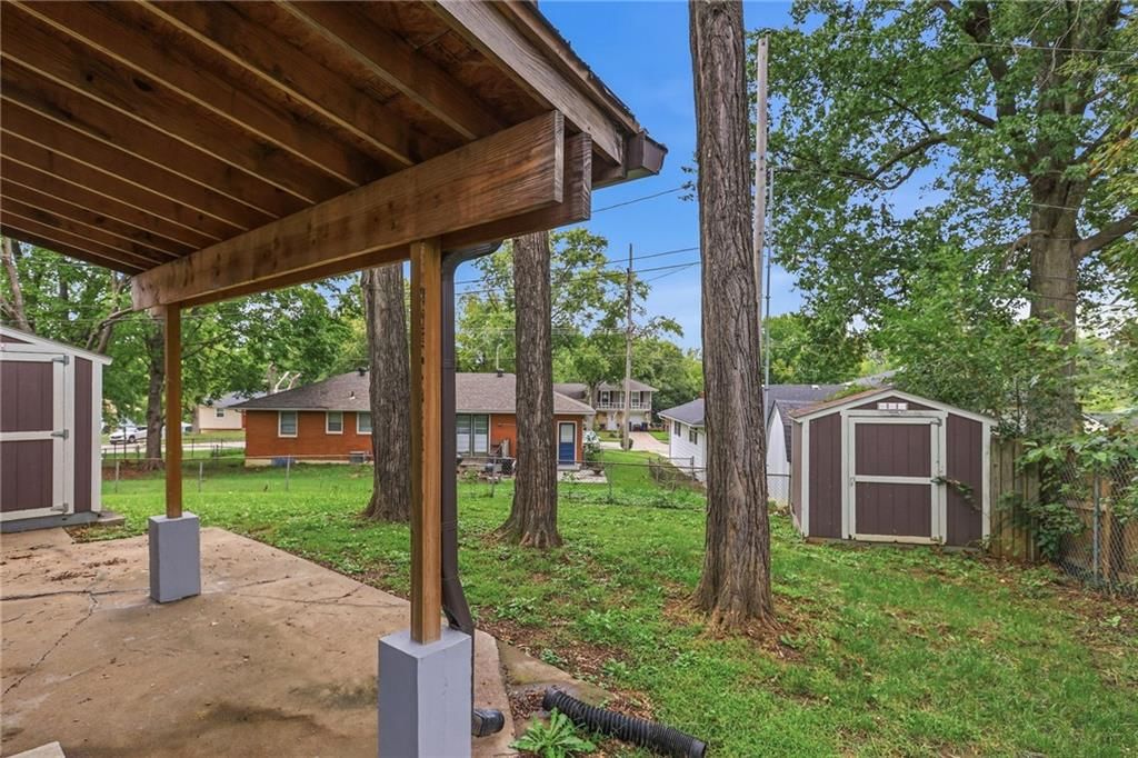 Fenced yard, covered patio and chain-link fence at 408 N Kirk Avenue, Independence, MO 64050