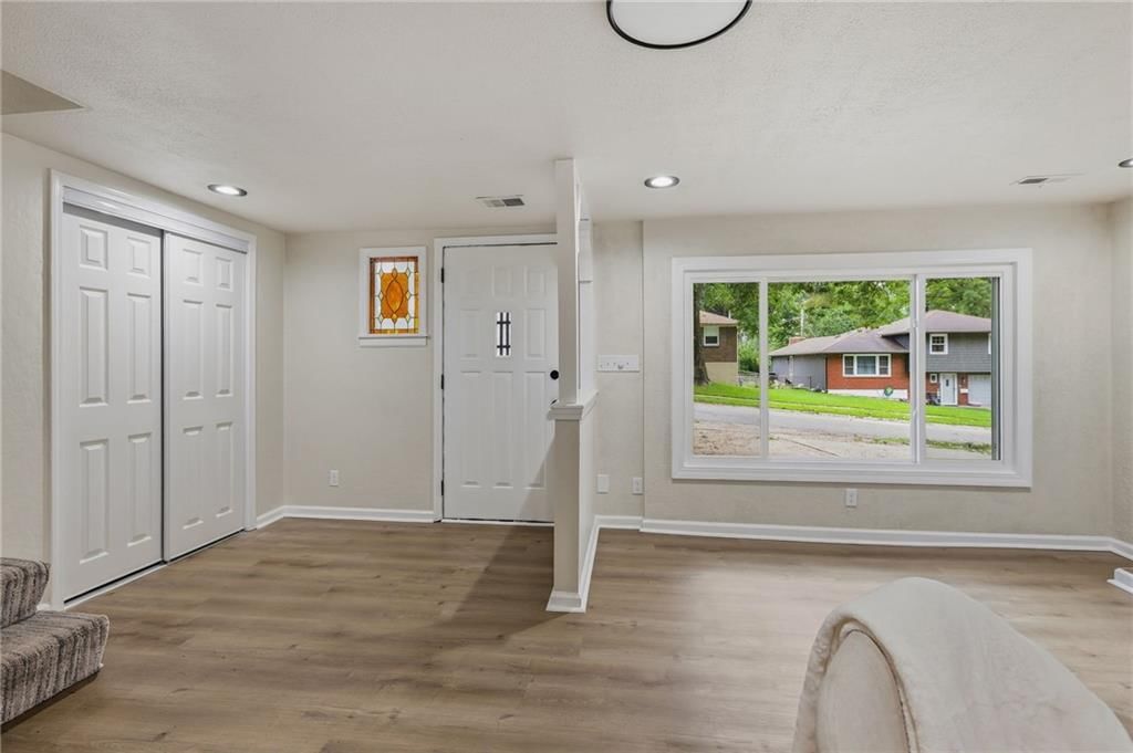 Luxury vinyl floors, recessed lighting and white trim at 408 N Kirk Avenue, Independence, MO 64050