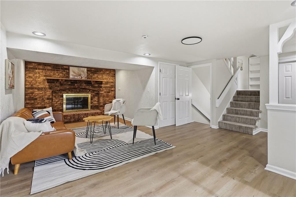 Fireplace, staircase and wood stair railing at 408 N Kirk Avenue, Independence, MO 64050