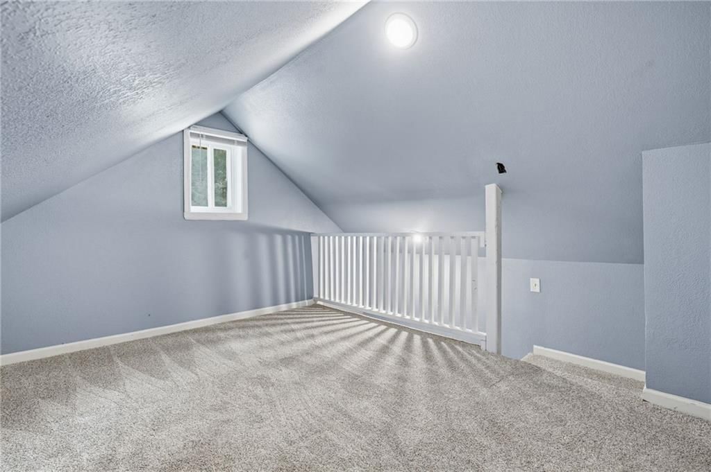 Loft, staircase and wood stair railing at 412 S Hocker Avenue, Independence, MO 64050
