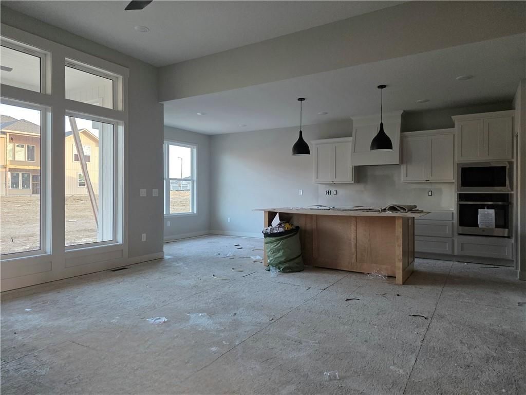 Open floor plan, kitchen island and white kitchen at 14594 Amanda Lane, Basehor, KS 66007