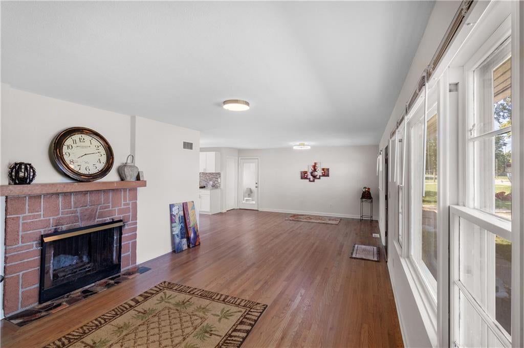 Fireplace, hardwood floors and white trim at 8657 E 57th Street, Kansas City, MO 64129