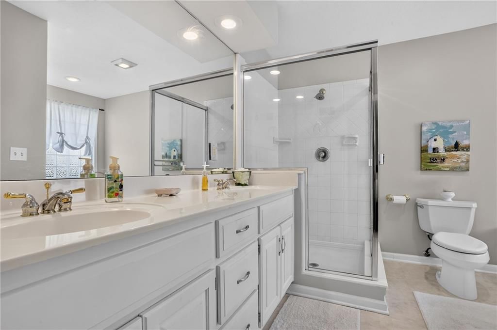Walk-in shower, tiled shower and double vanity at 7608 NW 76th Place, Kansas City, MO 64152