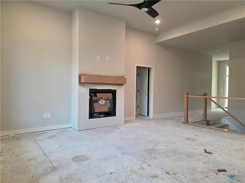 Fireplace, staircase and wood stair railing at 14584 Amanda Lane, Basehor, KS 66007