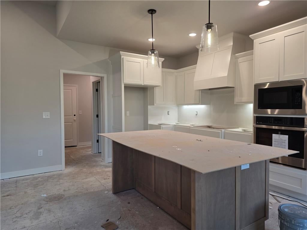 Kitchen island, white kitchen and shaker cabinets at 14584 Amanda Lane, Basehor, KS 66007