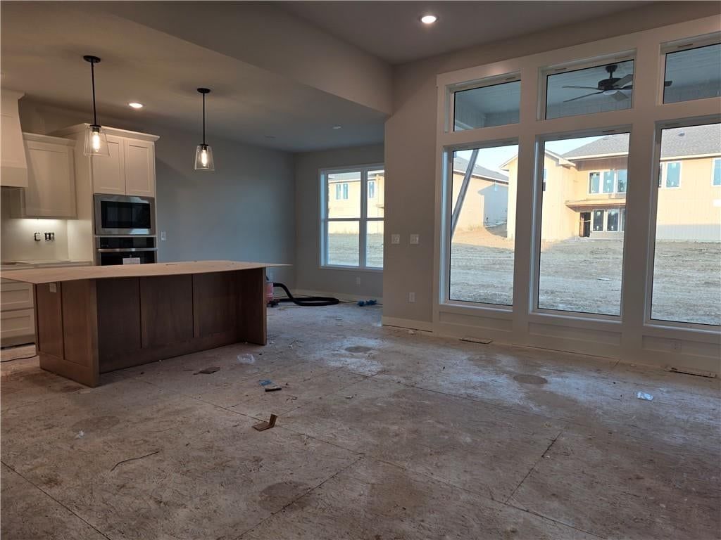 Open floor plan and wall of windows at 14584 Amanda Lane, Basehor, KS 66007