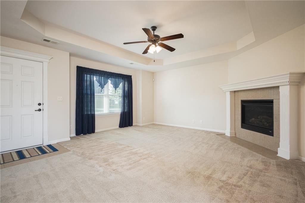 Fireplace, tray ceiling and tile fireplace at 101 Sun Garden Street, Blue Springs, MO 64064