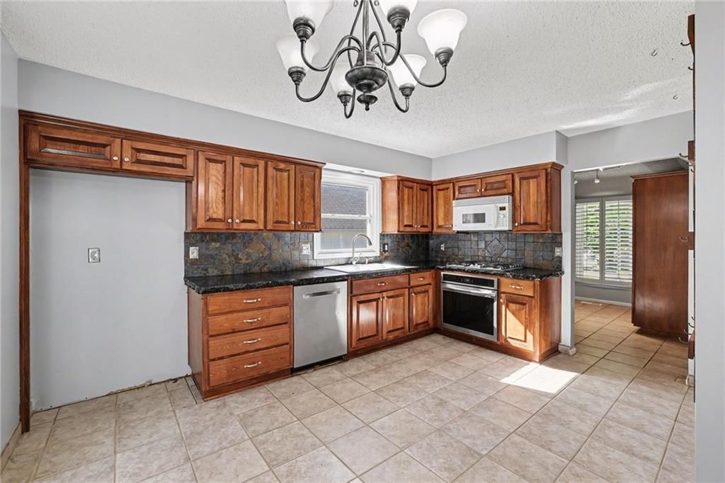 Stainless steel appliances, wood kitchen cabinets and kitchen backsplash at 5755 RICHARDS Circle, Shawnee, KS 66216